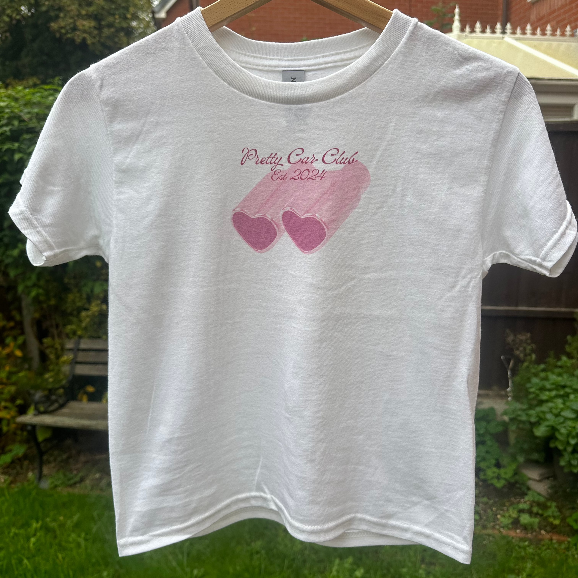 Pink car exhausts in the shape of hearts with the text "Pretty Car Club". A Silk and Chrome tshirt perfect for car girls.