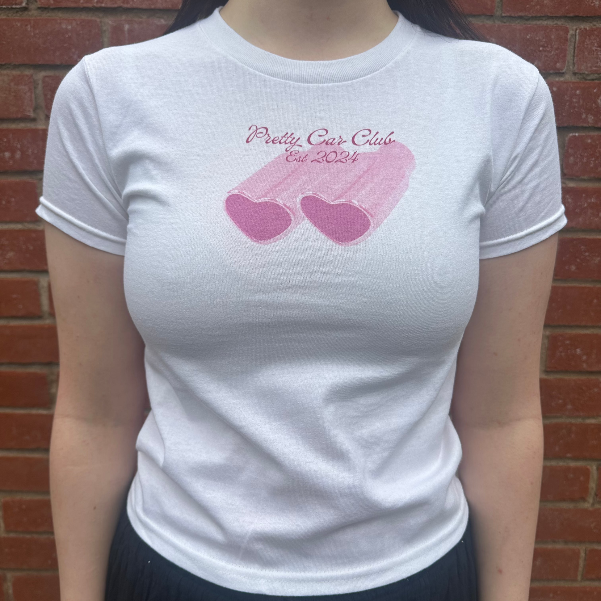 Silk and Chrome pink heart-shaped car exhausts design baby tee. 